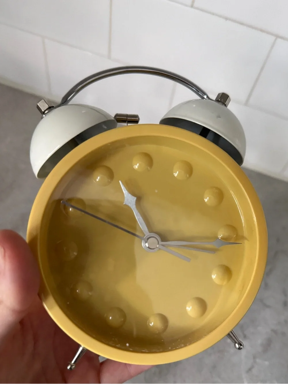 Vintage yellow Karlsson Chaplin alarm clock features a distinctive minimalist